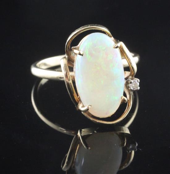 A 1980s 14ct gold, white opal and diamond set oval dress ring, size N.
